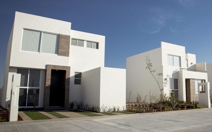 A closeup shot of a complex of white and brown modern building blocks with sunshine