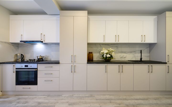 Interior of a large spacious beige and cream luxury kitchen, front view to furniture
